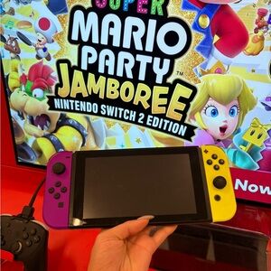 Nintendo Switch with Vibrant Purple and Yellow Joy-Con free games